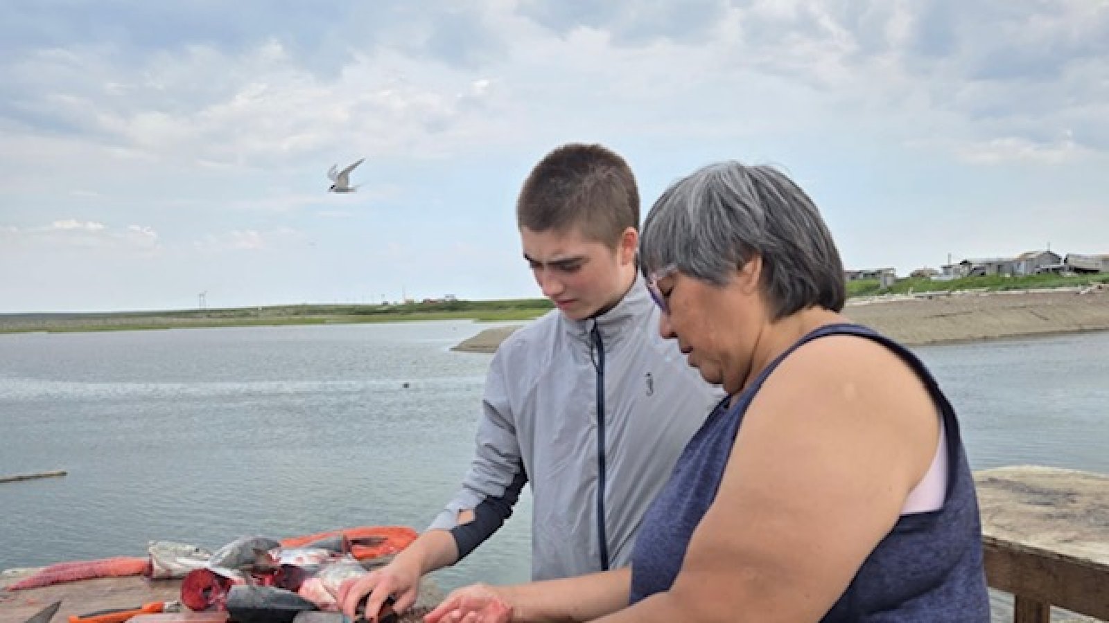 Annette teaching me how to cut salmon for drying