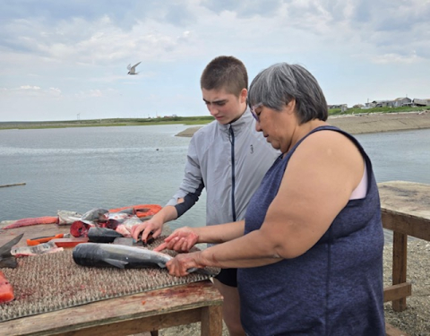 Annette teaching me how to cut salmon for drying