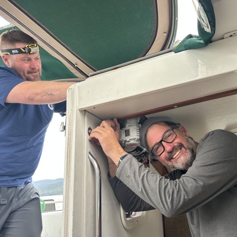 2 people working on electric winch