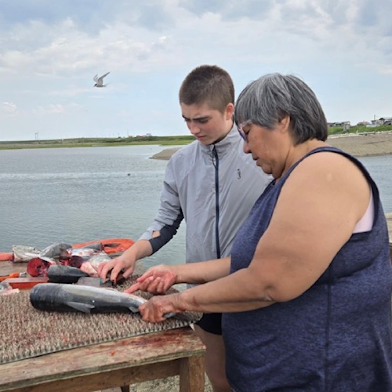 Annette teaching me how to cut salmon for drying